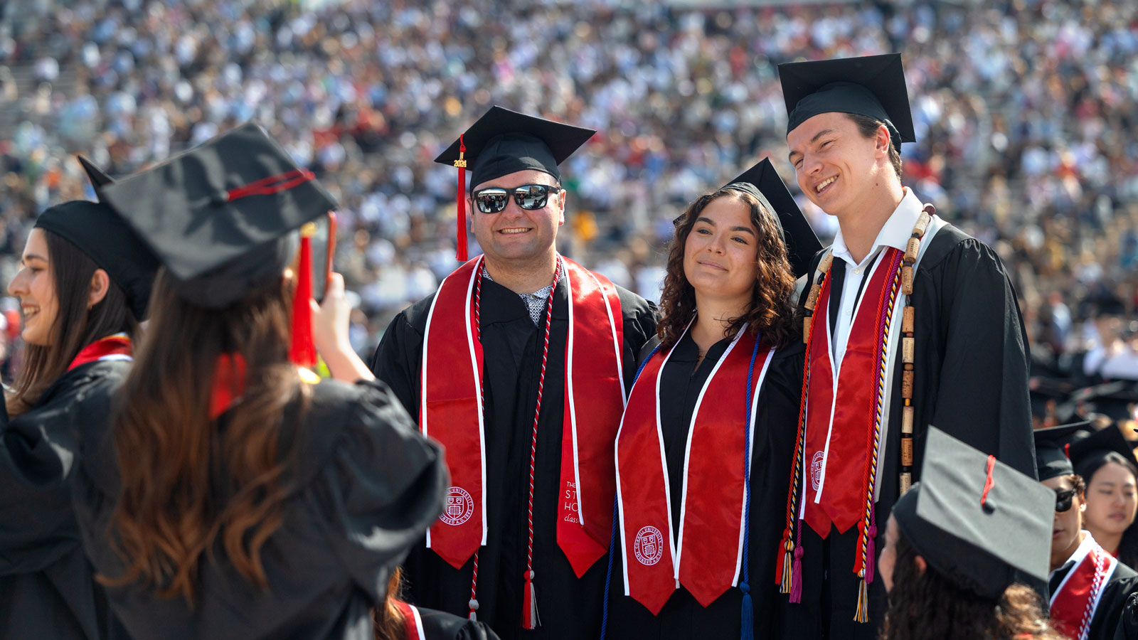 Graduates pose for a photo in Schoellkopf Stadium as part of Commencement 2024 events