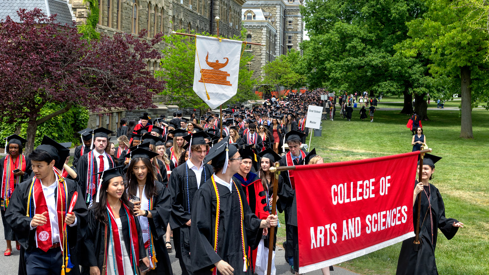 College of Arts and Sciences graduates carry their college banner during the academic procession as part of Commencement 2024 events