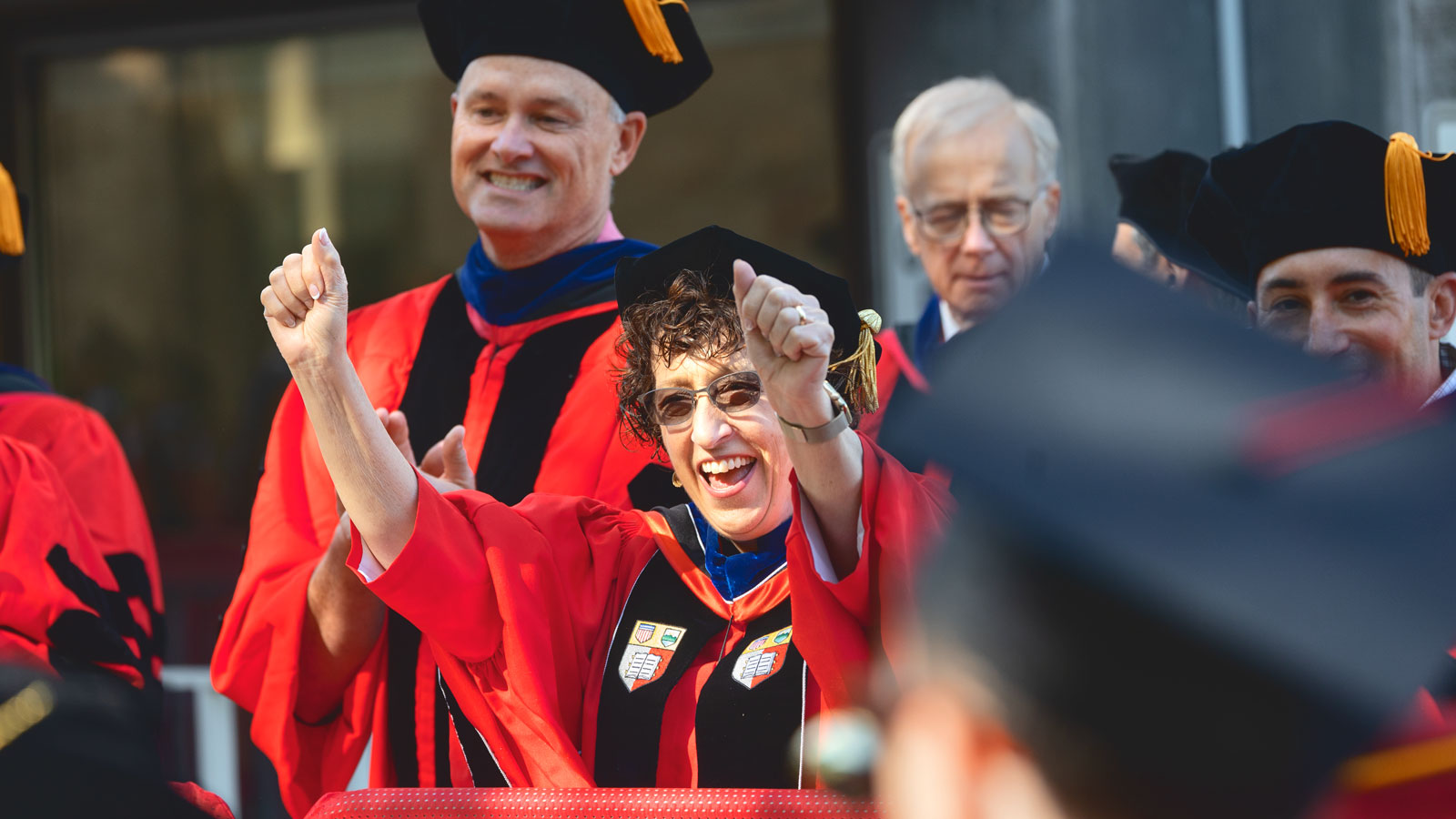 President Pollack raises her hands at Commencement 2024