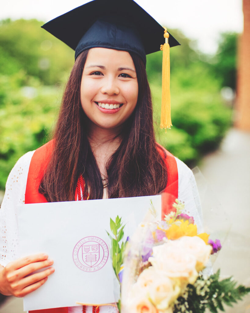 Jessica Kwong smiles with her graduation cap and gown on 