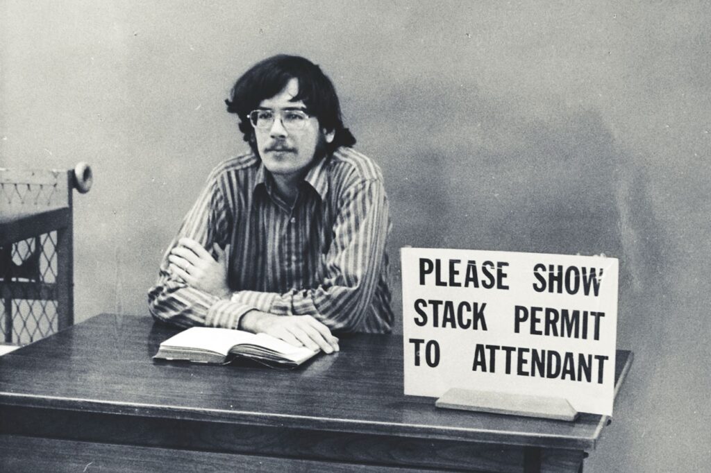 1972 photo shows a library employee at a checkpoint that made sure everyone entering the stacks had a pass