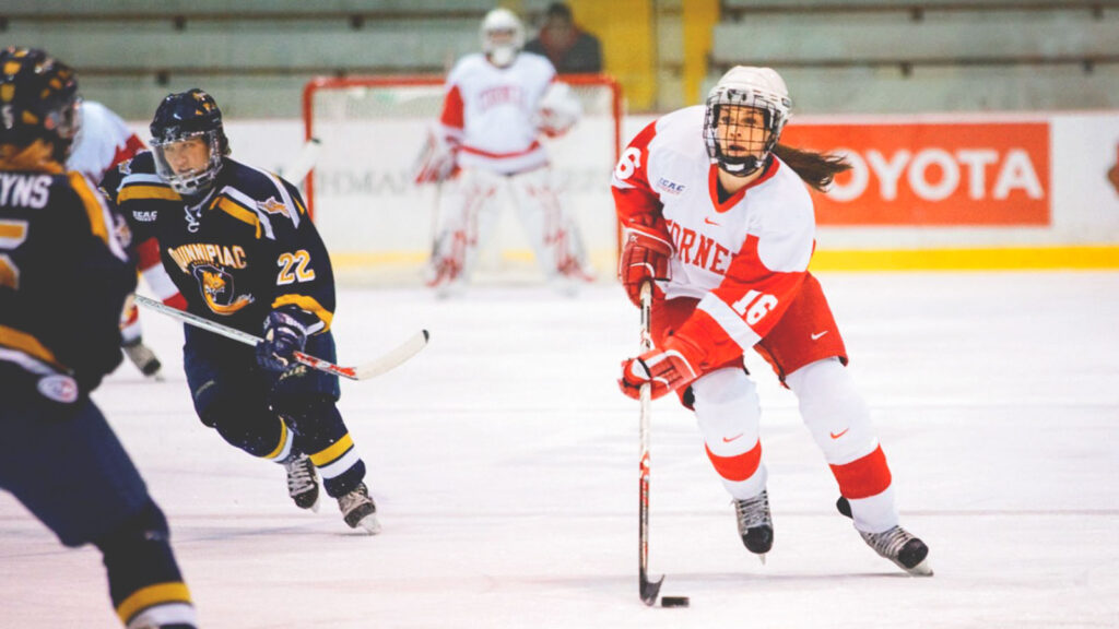 Rebecca Johnston ’11, BS ’12 playing hockey for the Big Red