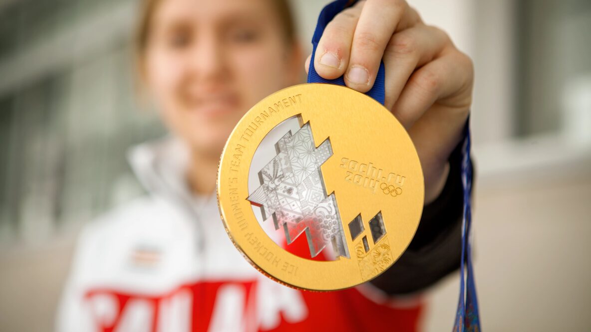 Brianne Jenner with the gold medal she won at the 2014 Sochi winter olympics as part of the team Canada women's hockey team.