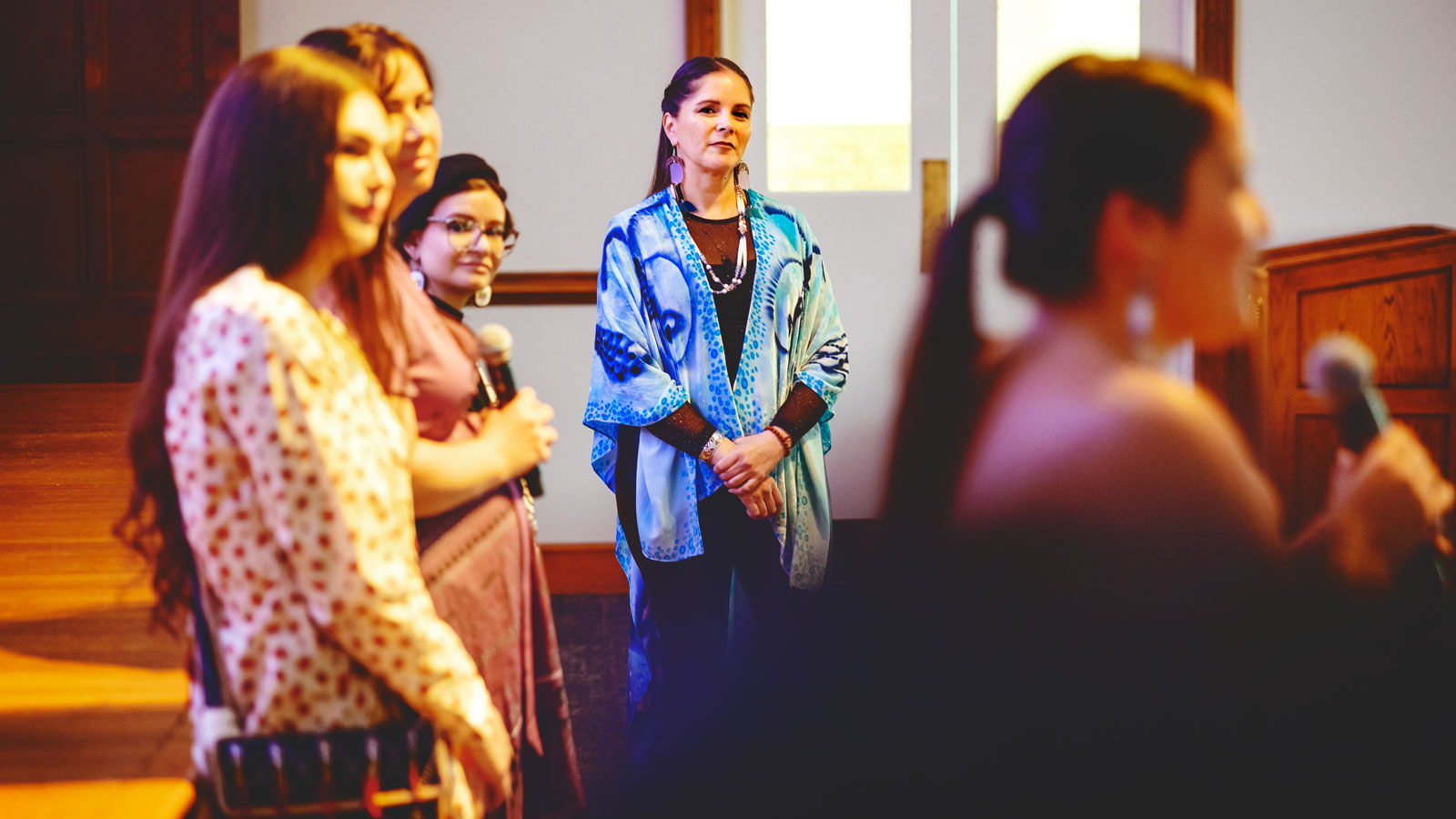 Michelle Schenandoah watches Cornell students as they speak at Rematriation: The Fashion Show.