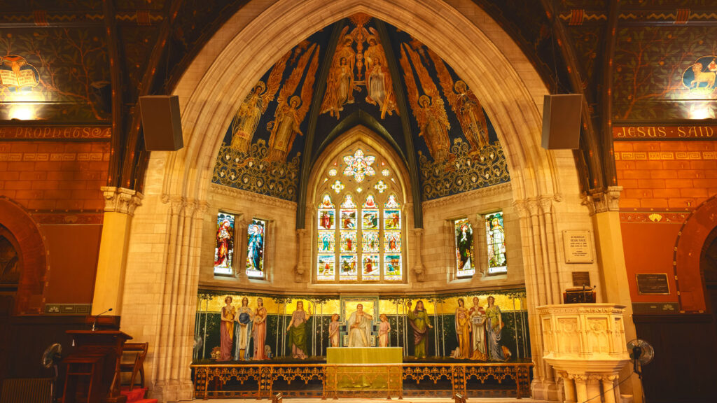 view of the chancel addition to Sage Chapel, with mosaics, decorated ceiling, and stained-glass windows in Sage Chapel