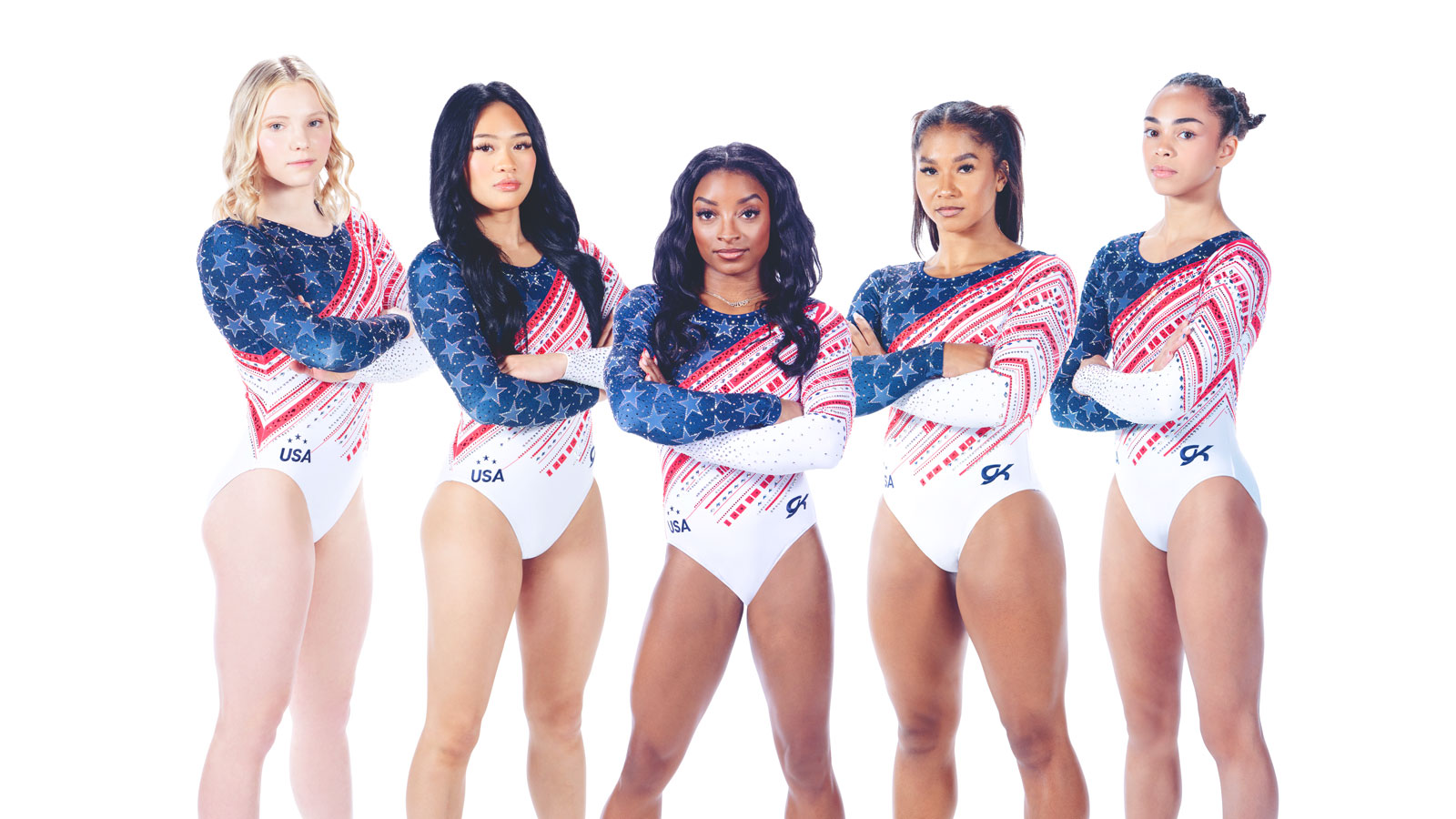 Five team USA gymnasts wearing their red, white, and blue uniforms