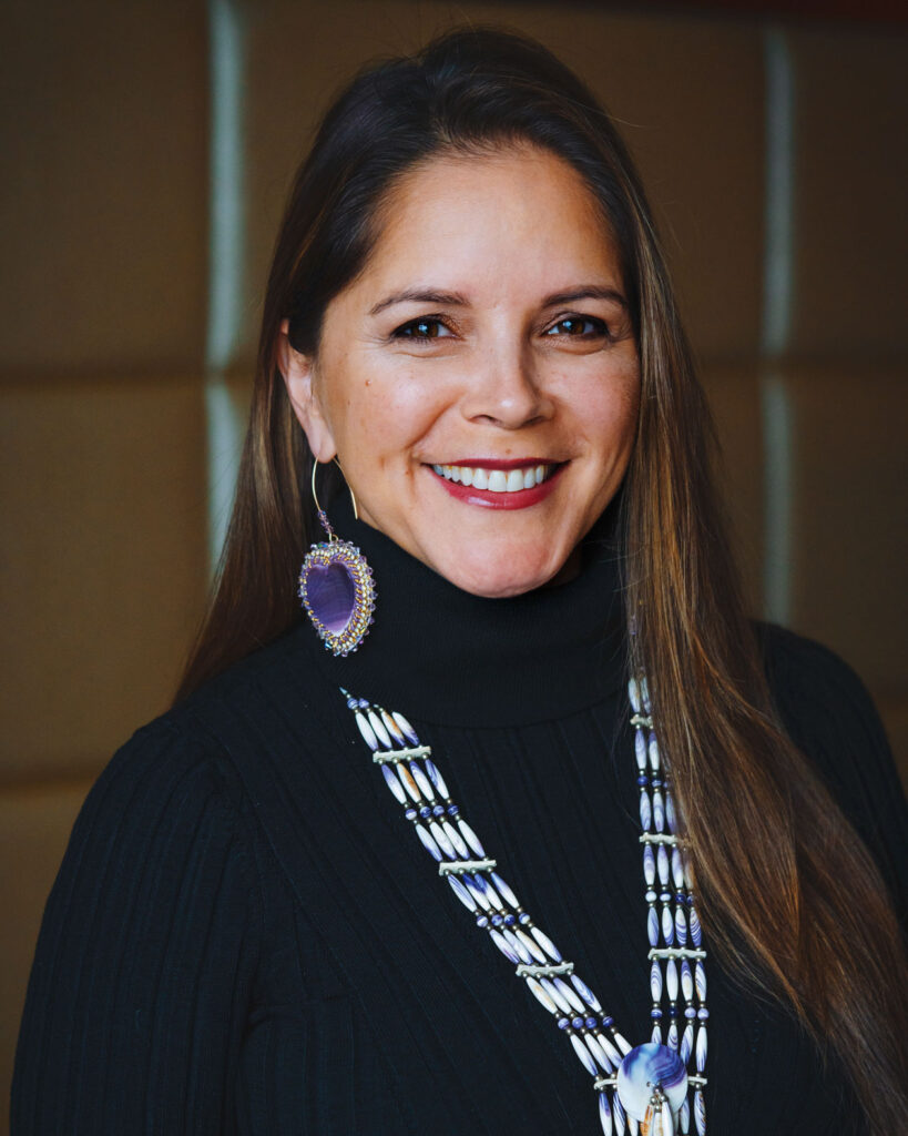 A headshot of Michelle Schenandoah during a team meeting.