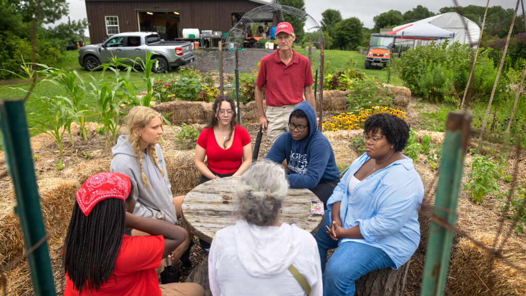 Students and staff meet at a Dilmun Hill student farm open house.