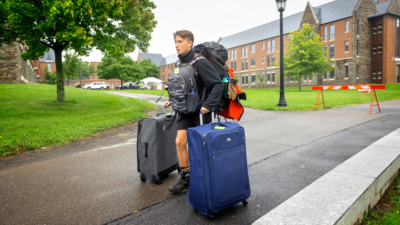 A student traverses North Campus with bags in tow during Move-In 2024