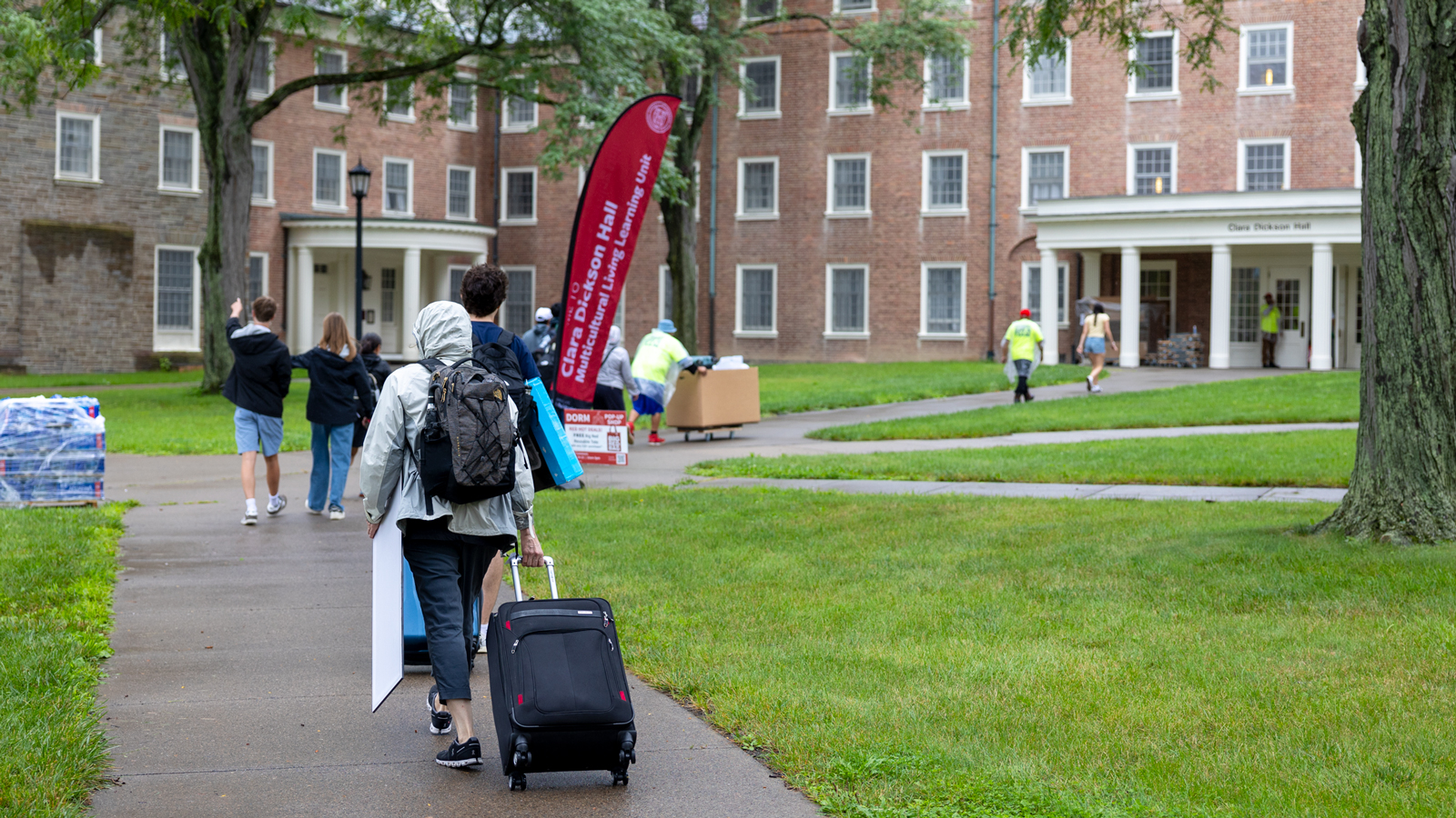 Students carry and wheel their belongings on North Campus during Move-In 2024