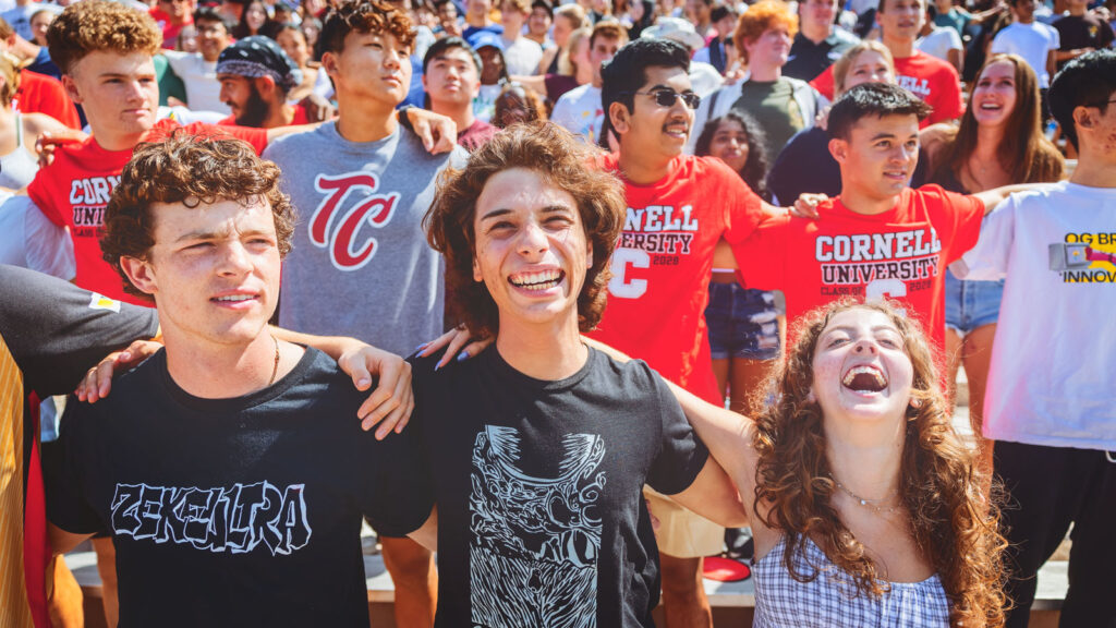 New students with their arms around each other at Convocation.