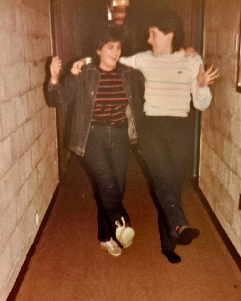 The cinderblock walls are visible in this image of two residents in a U-Hall hallway, 1984