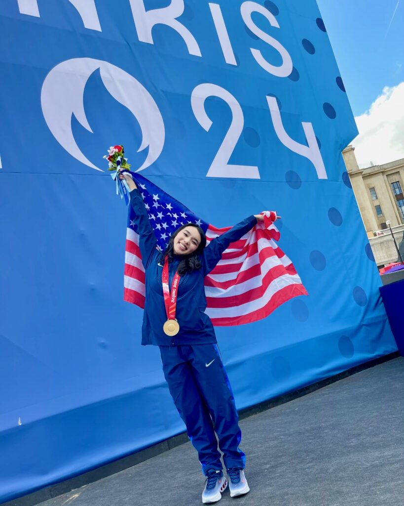 Karen Chen ’23 with an American flag and her gold medal in Paris, 2024