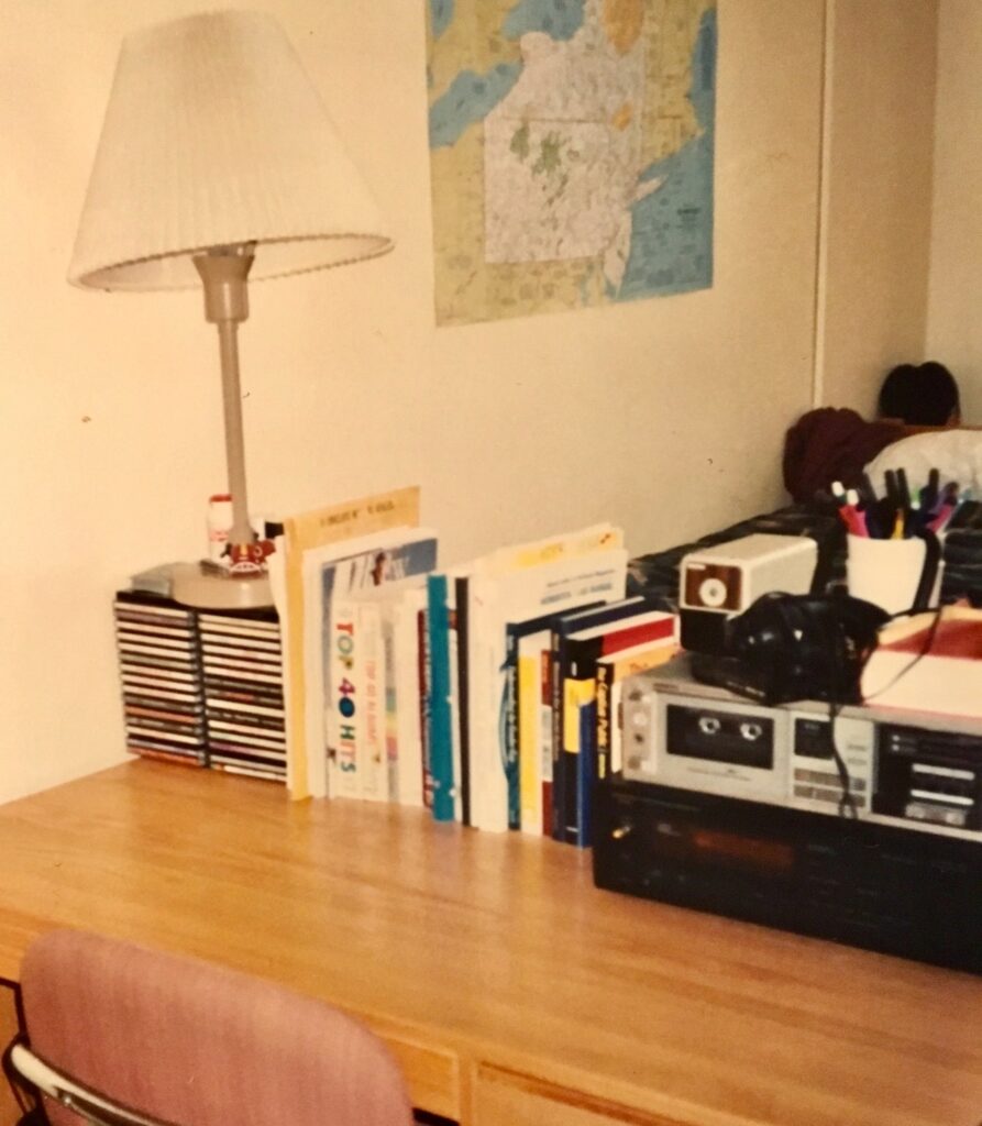 detail of items on a dorm room desk on campus, 1992-93