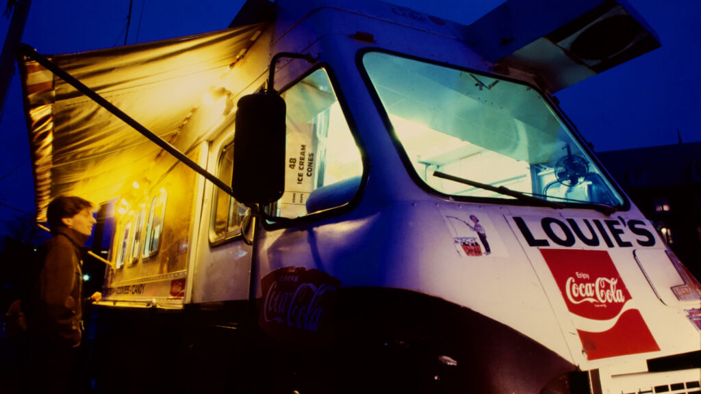 View of Louie’s Lunch Truck with a patron visible at night, 1984