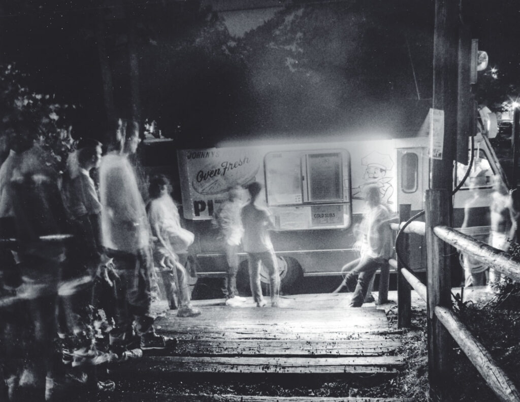 long-exposure image of students waiting for their orders at the Hot Truck at night, 1987