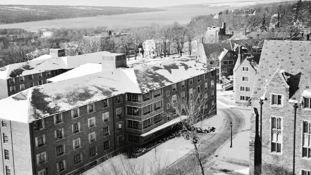 Winter shot of West Campus and the University Halls with Cayuga Lake in the background, 1960s