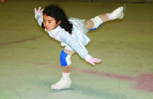 Karen Chen as a child in a light blue skating dress, practicing a spiral.