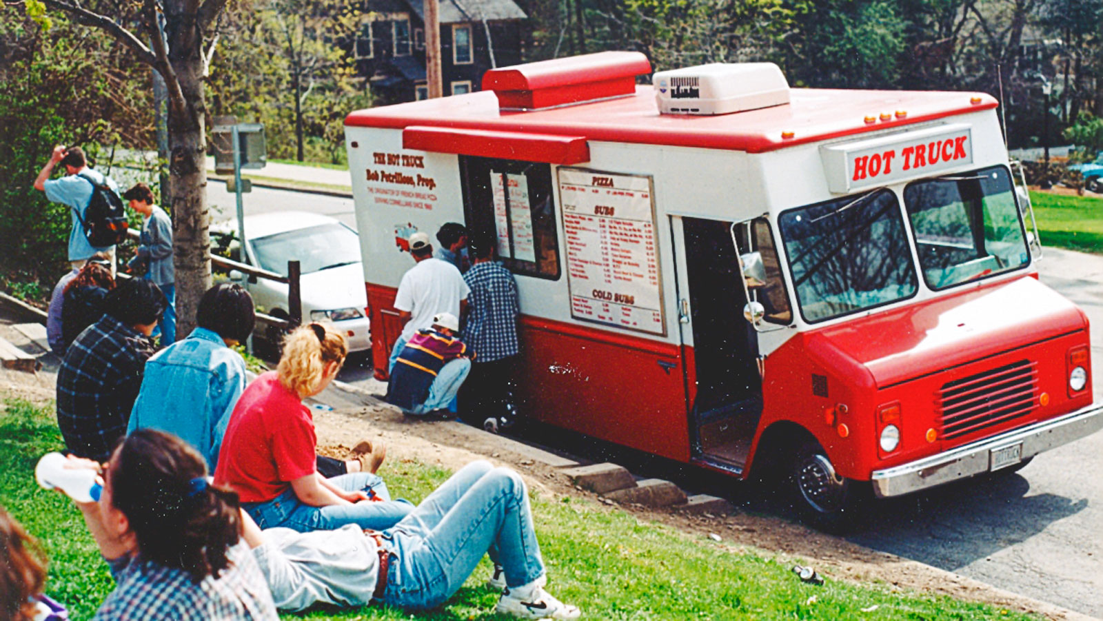 image of the Hot Truck on Stewart Avenue with students waiting on the grassy slope