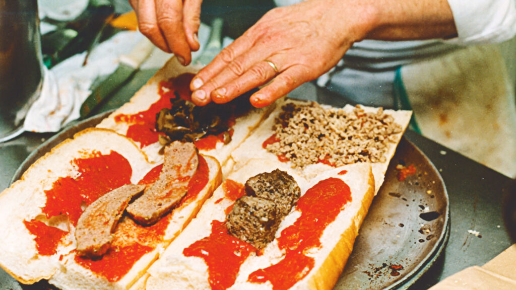 close-up of Bob Petrillose making a French bread pizza sub in the Hot Truck