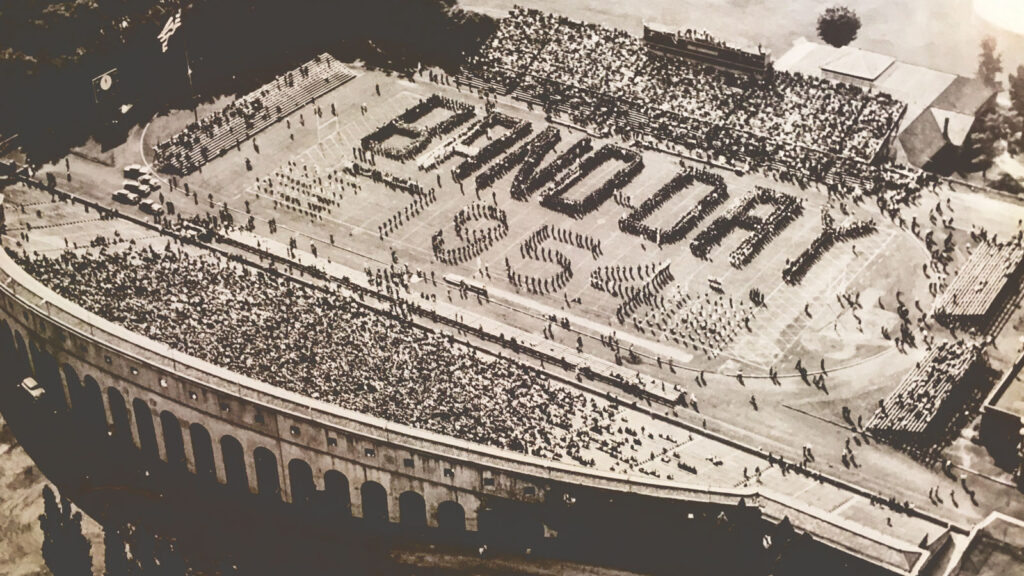 aerial photo of Band Day 1954, showing hundreds of regional band members spelling out “Band Day 1954” on Schoellkopf Field