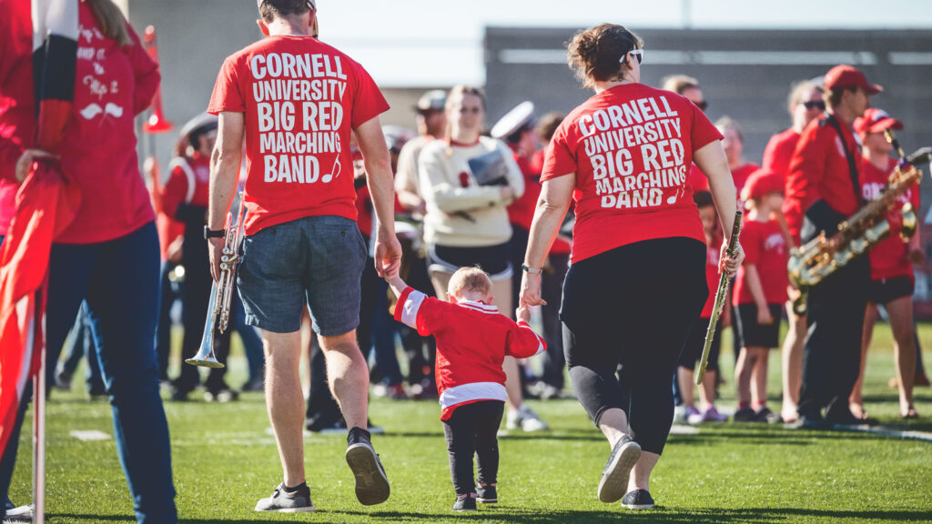 Band alumni bring a very young band member-to-be to Homecoming Weekend 2023