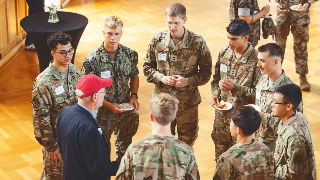 Interim President Mike Kotlikoff speaks with student veterans during a welcome event in the Willard Straight Hall Memorial Room in 2024