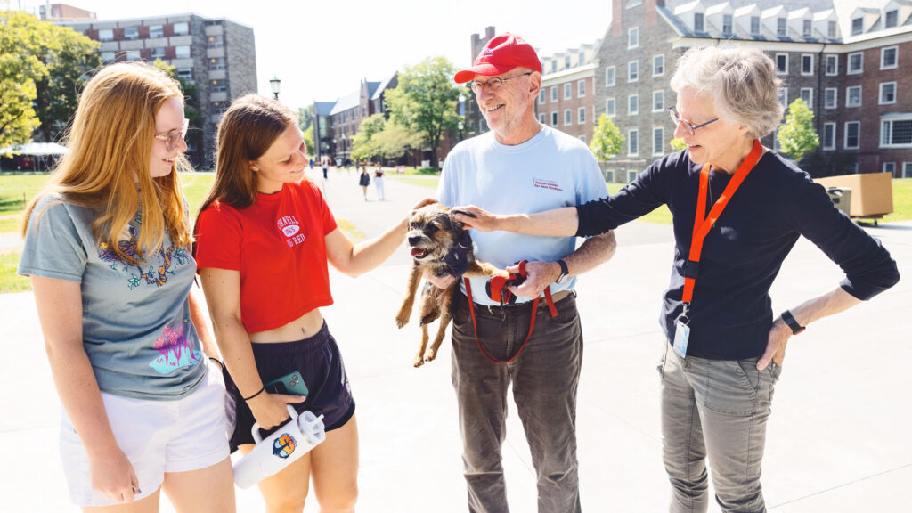 Mike Kotlikoff and wife Carolyn McDaniel with their dog, May, greeting new students on North Campus.