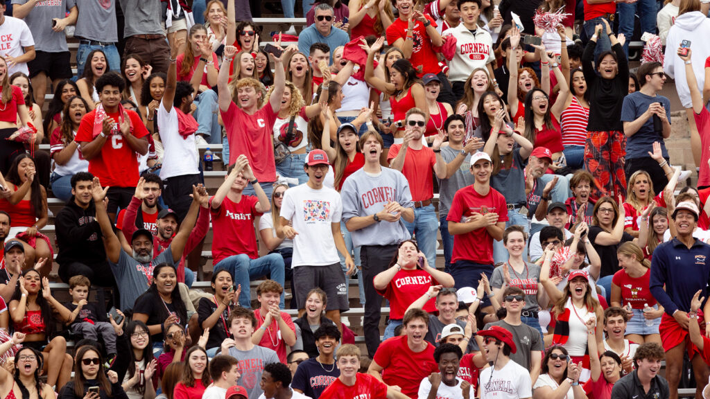 dozens of fans cheer during the Big Red football game at Schoellkopf Field during Homecoming 2024