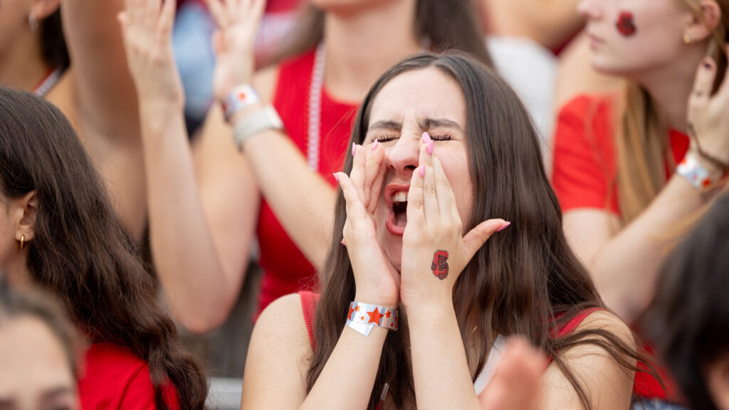 a fan cheers during the Big Red football game at Schoellkopf Field during Homecoming 2024