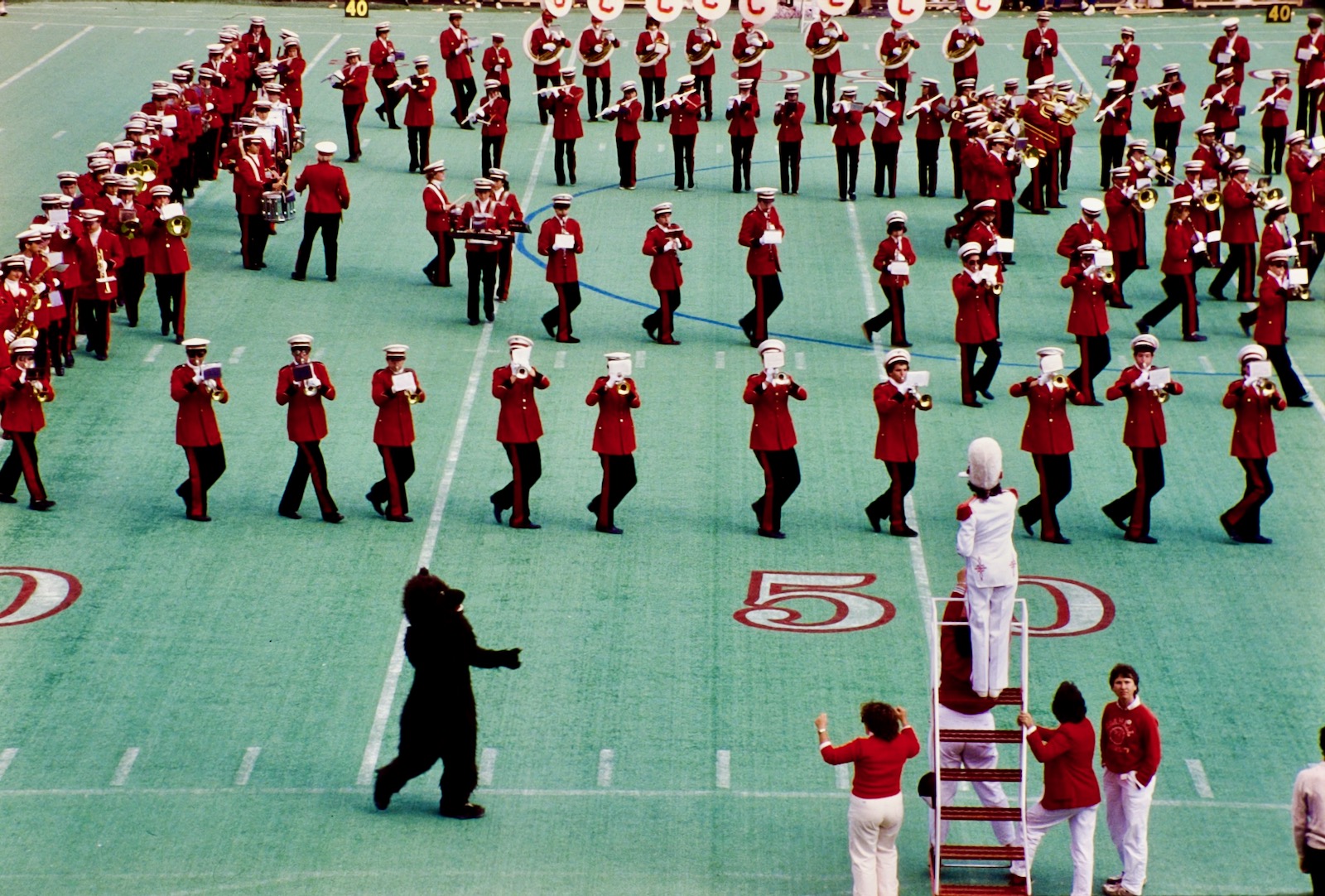 The band performs on Schoellkopf Field (with the Big Red Bear making an appearance) in 1984