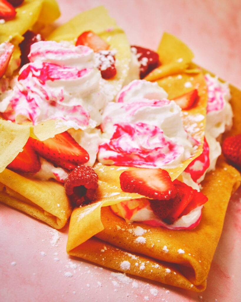 Whipnotic flavored whipped cream on strawberry crepes.