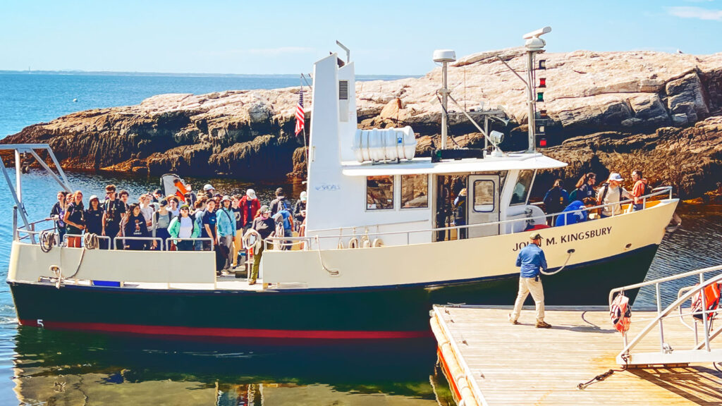 Students arriving to the island on the boat.