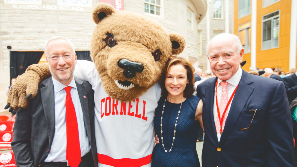 then-Provost Mike Kotlikoff poses with The Big Red Bear, Franci Blassberg, and Joe Rice at the dedication of Klarman Hall in 2016