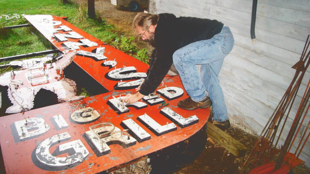 Tod Swormstedt prepares to load the Johnny's Big Red Grill sign on a trailer for the trip to Cincinnati in 2009