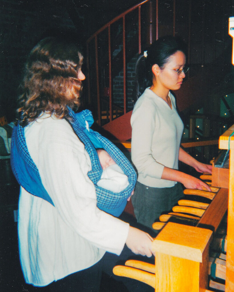 Jennifer Lory-Moran mentoring a chimesmaster in 2002 with her newborn.