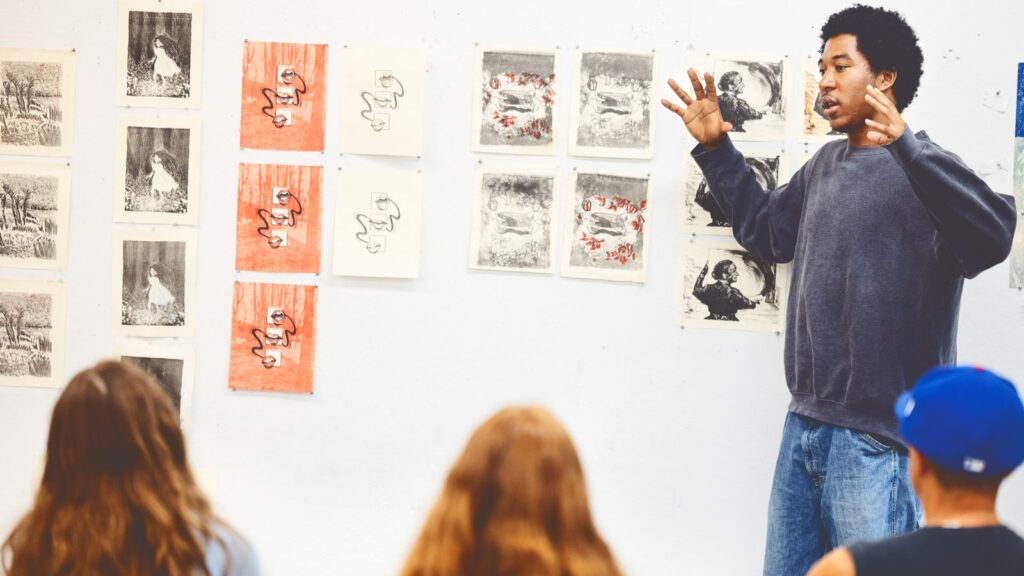 Summer printmaking class students participate in a critique session in Tjaden Hall