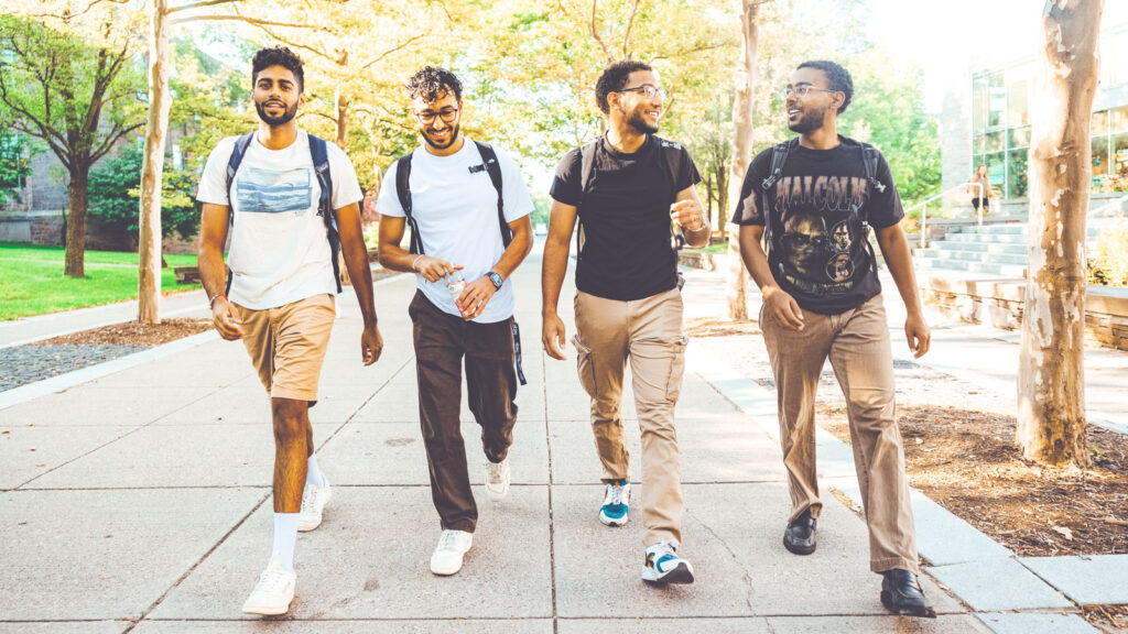 Four male students walking on the first day of classes of the 2024 fall semester.