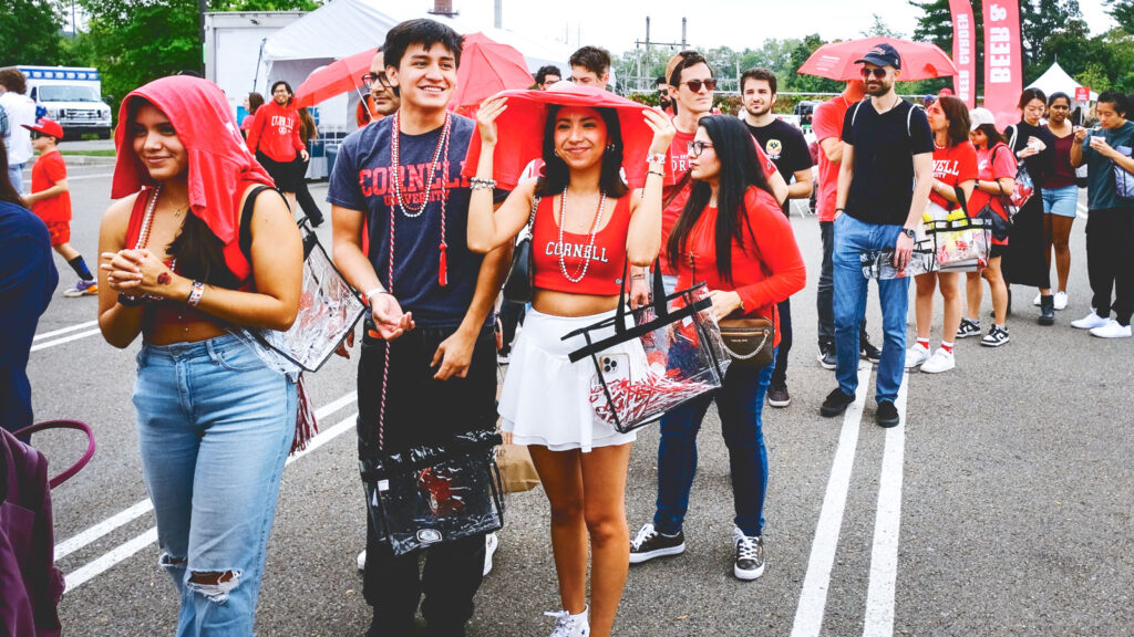 Students, alumni, and others wait on line in the Crescent Lot despite a bit of rain to participate in Cornellians’ Homecoming 2024 exercise recalling their fondest memories of life on the Hill