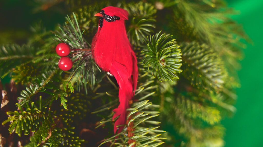 A decorative cardinal perched in a wreath.