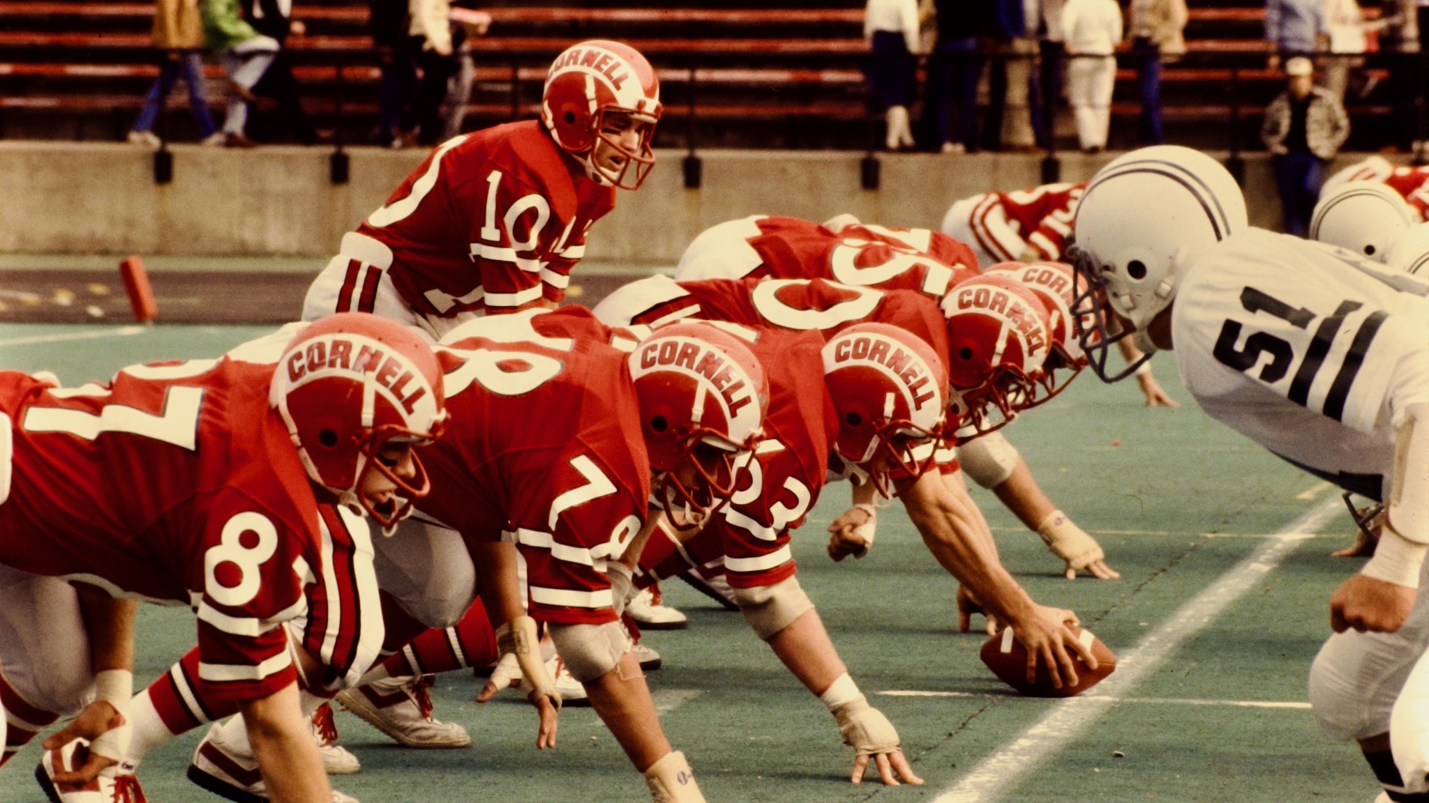 members of the Big Red football team ready for a play, 1977