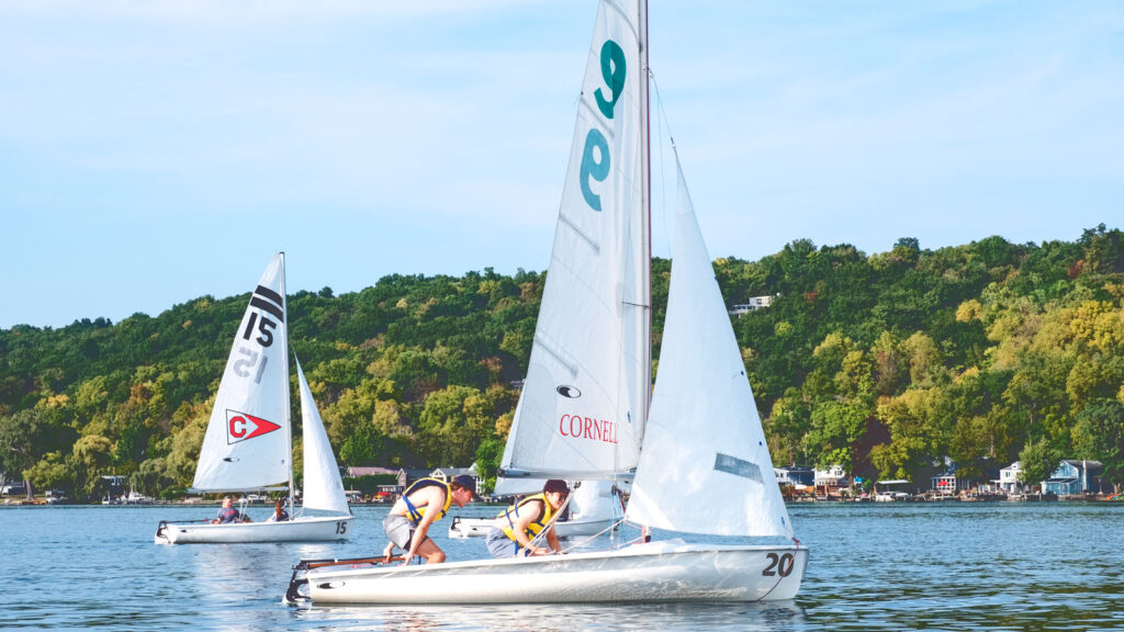 two students in the class on one of the "420" sailboats