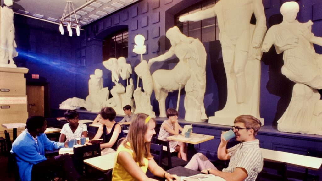 students relax at the Temple of Zeus in Goldwin Smith Hall, surrounded by the plaster statues that used to be displayed there, 1967