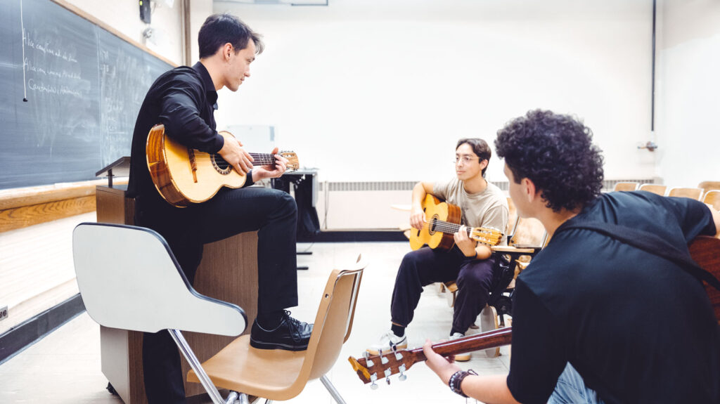 Members of the Mariachi Regional de Cornell University group during a guitar lesson together.