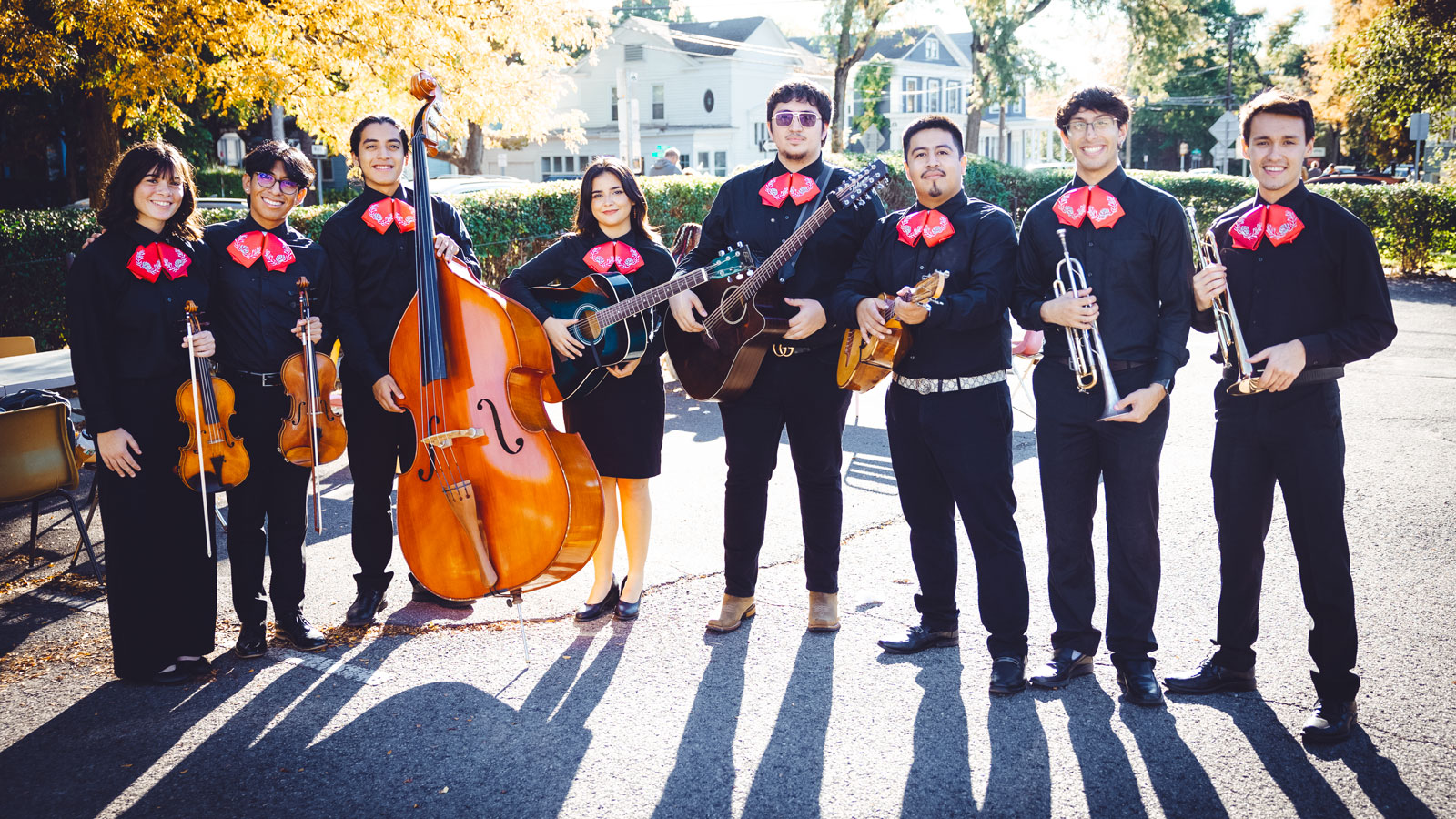 The Mariachi Regional de Cornell University in their matching outfits holding their instruments.