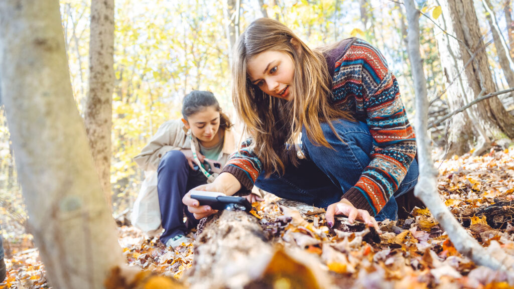 Two members of the student group Fantastic Fungi Fanatics explore while on a fungus hike through Ringwood Ponds