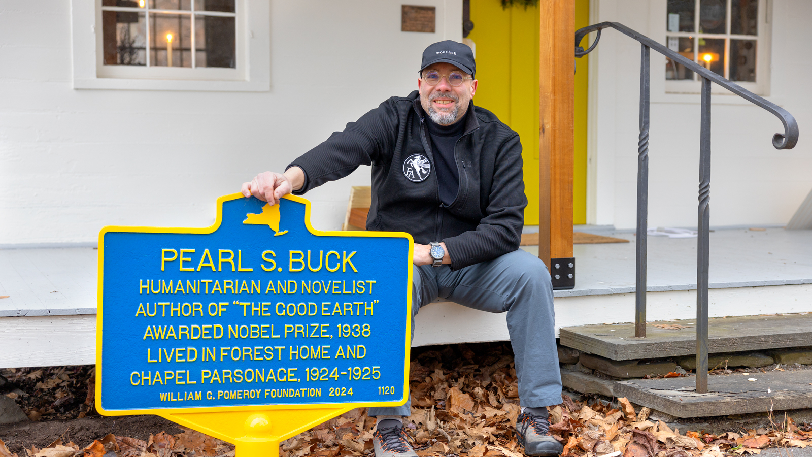 Thomas Campanella poses for a photograph with the historical marker honoring Pearl Buck on Wednesday, December 4, 2024. (Ryan Young / Cornell University)