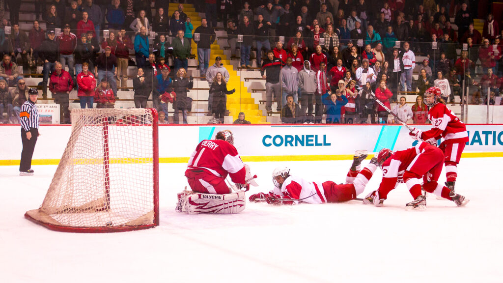 Laurianne Rougeau falls to the ice as she scores the game-winning goal in an 8-7 triple overtime victory over Boston University in an NCAA Quarterfinal game at Lynah Rink on March 14, 2012