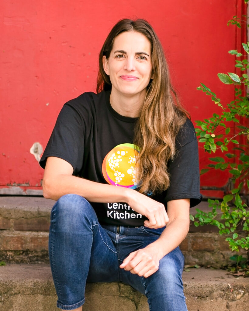 Katie Button sitting and wearing a World Central Kitchen t-shirt