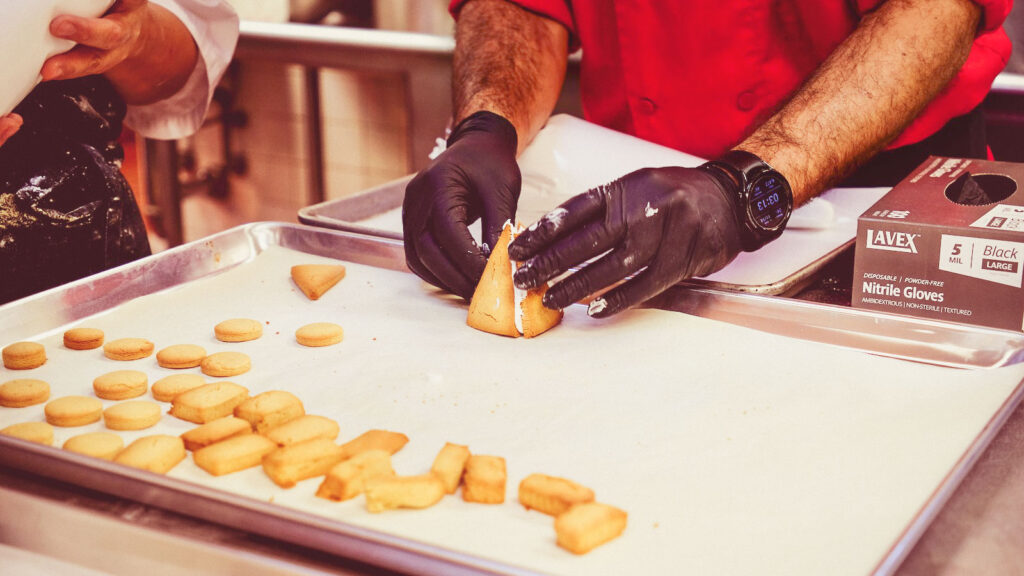 Kelvin Gomez, executive sous chef at the Cornell Club-NYC, puts the tower roof pieces together